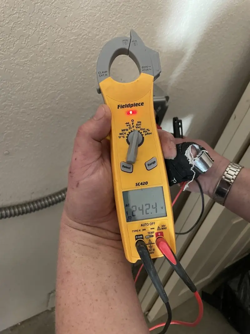 Voltage testing with clamp meter during Outlet Installation in Henderson